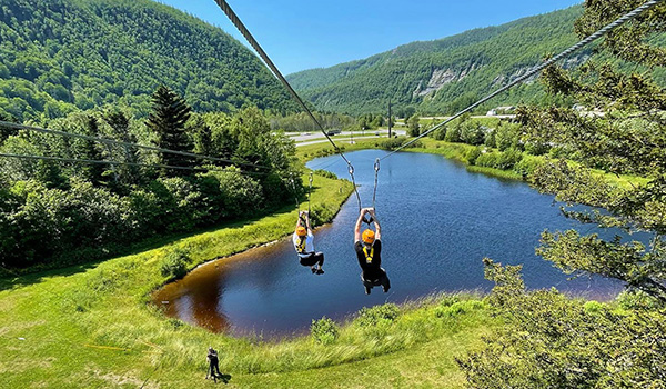 Two people on a zip line.