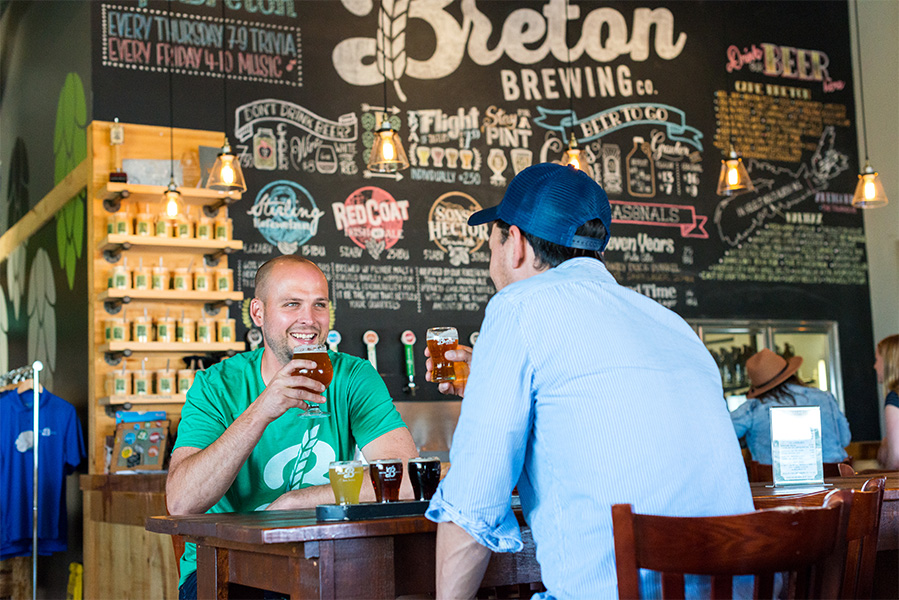 Inside Breton Brewing, two people enjoying beers.