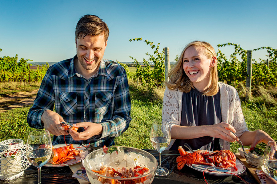 Two people enjoying a lobster dinner in the Annapolis Valley.