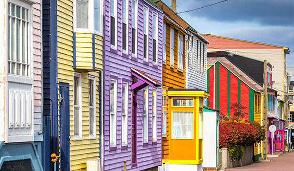 A row of brightly painted houses in the downtown area.