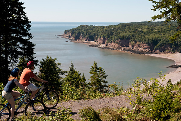 People cycling on the Fundy Parkway trail.