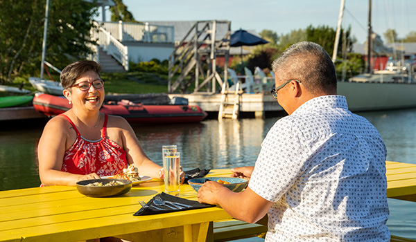 Two people eating outside at the Lakeside Restaurant.