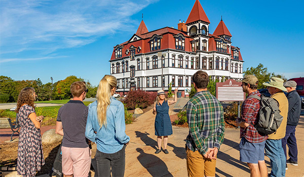 Tour guide and tourists outside of the The Lunenburg Academy